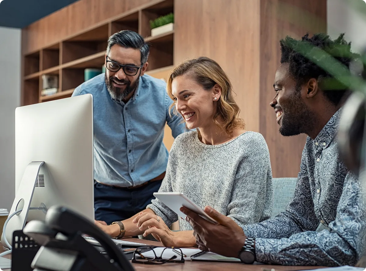 A team reviewing access settings together at a workstation