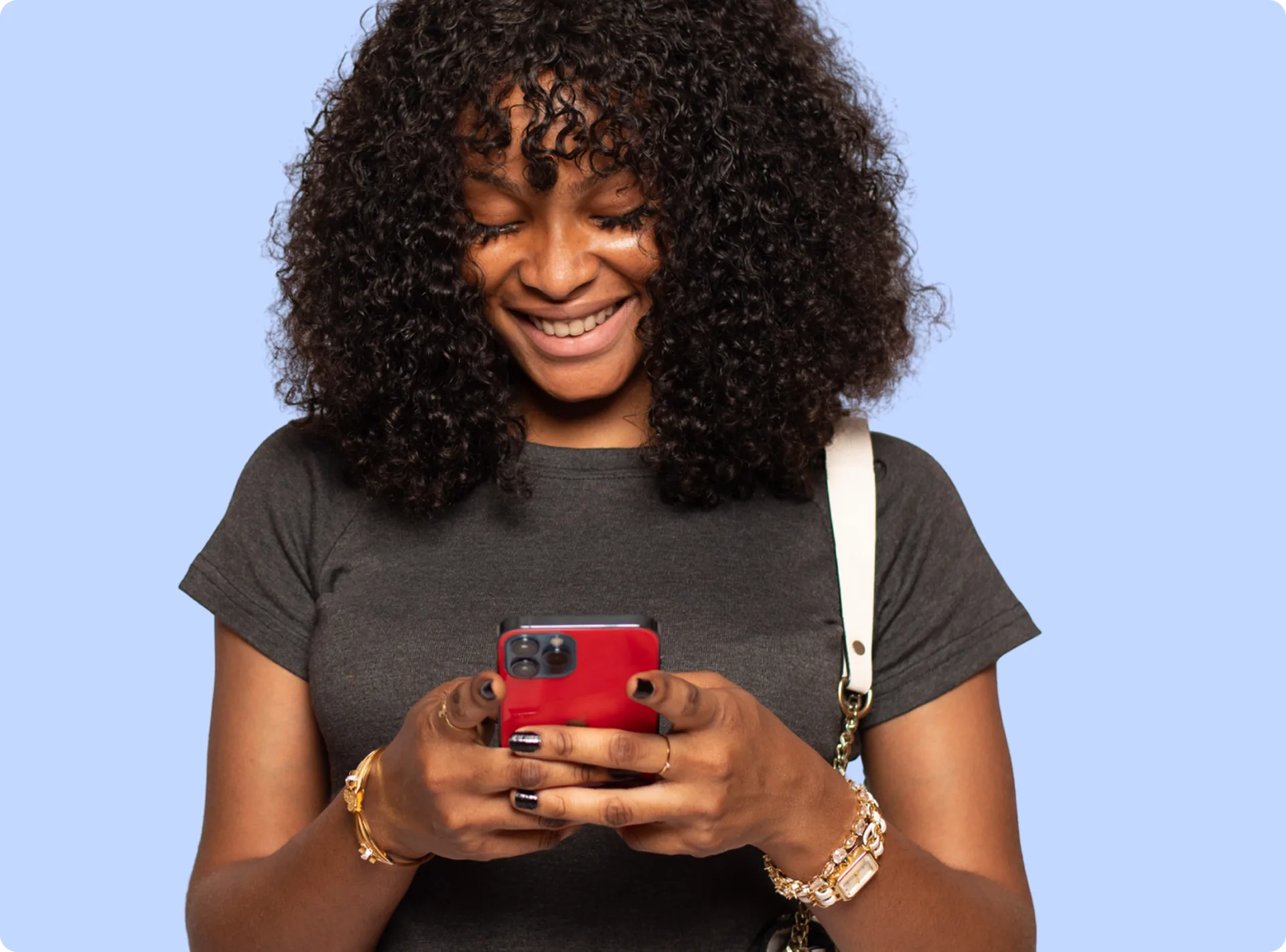 A student smiling at a message on their phone
