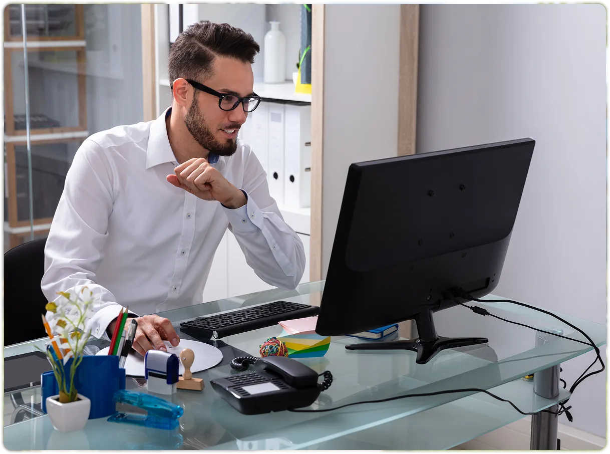 A landlord reviewing property records at a desktop computer