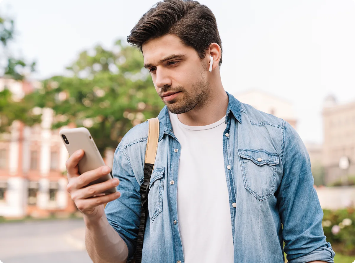 A resident checking their phone outdoors