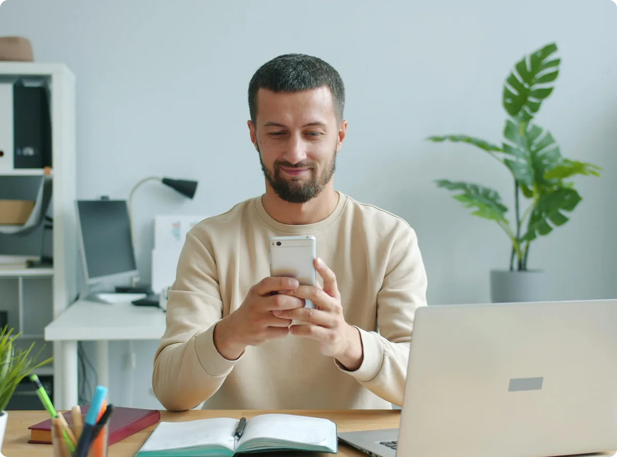 A resident reviewing payments on a phone at a desk