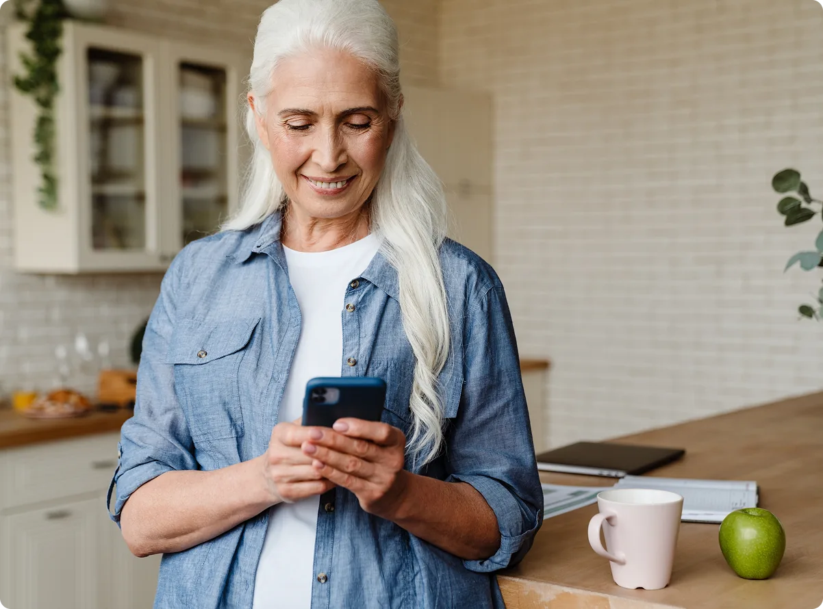A resident reading a notification on a phone at home