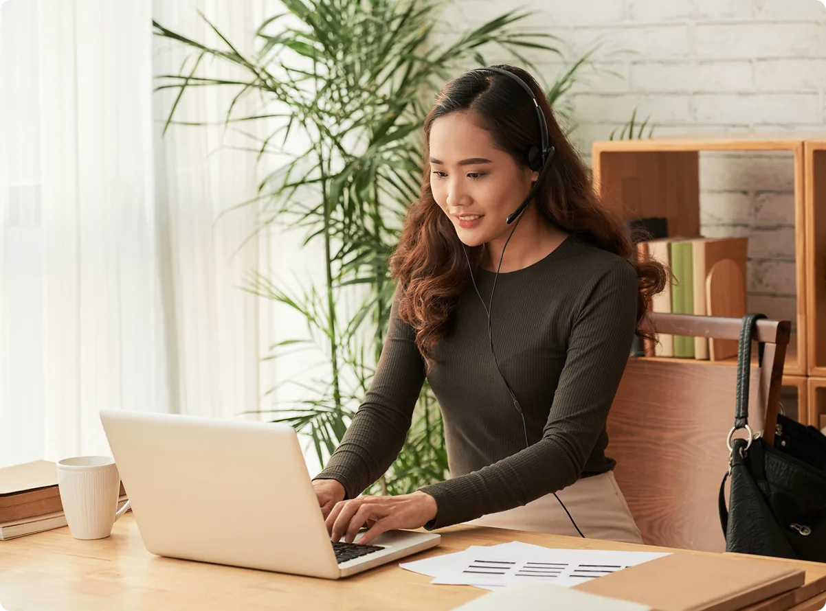 An operator working at a laptop with a headset