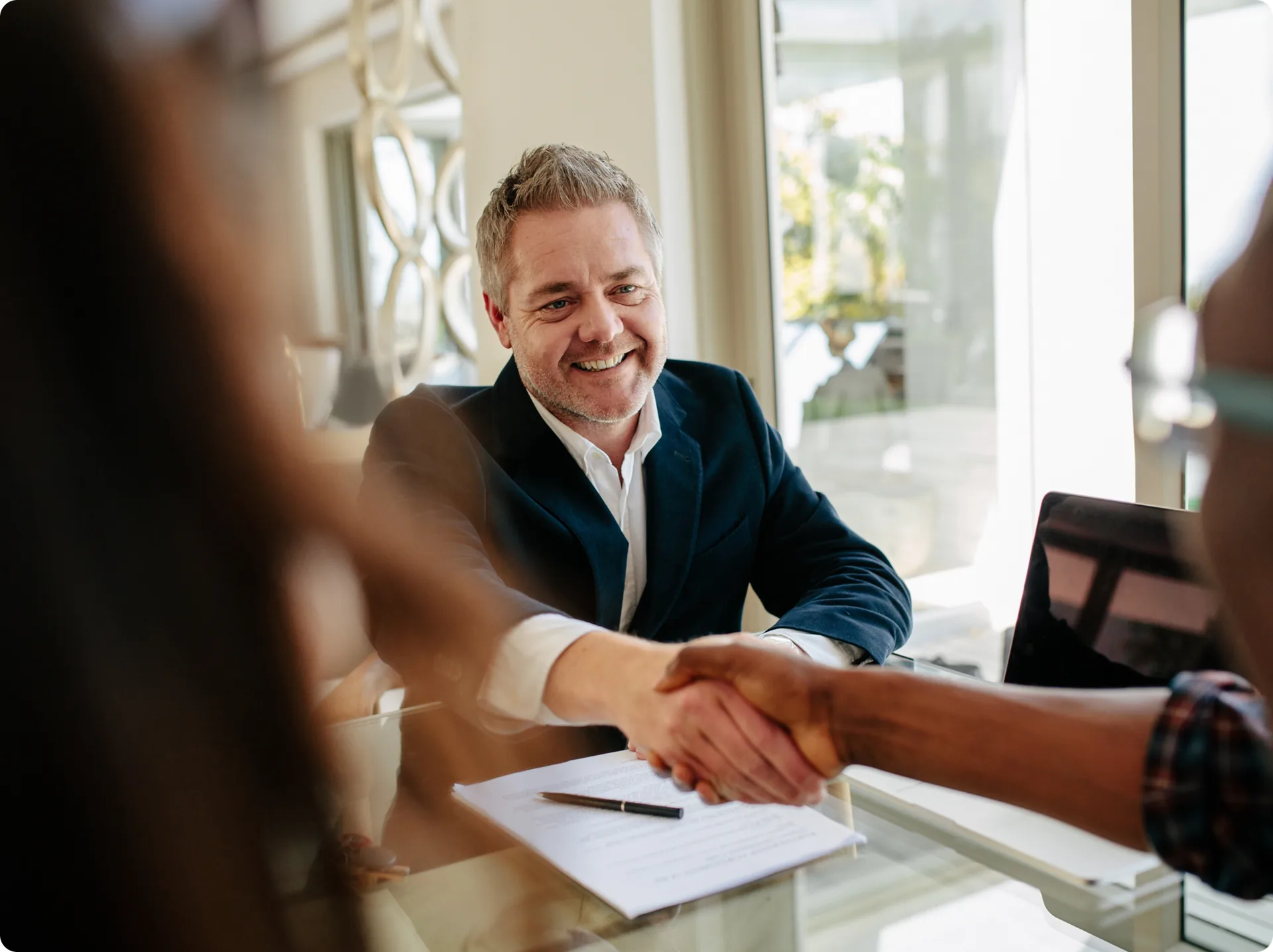Two people shaking hands after settling a payment