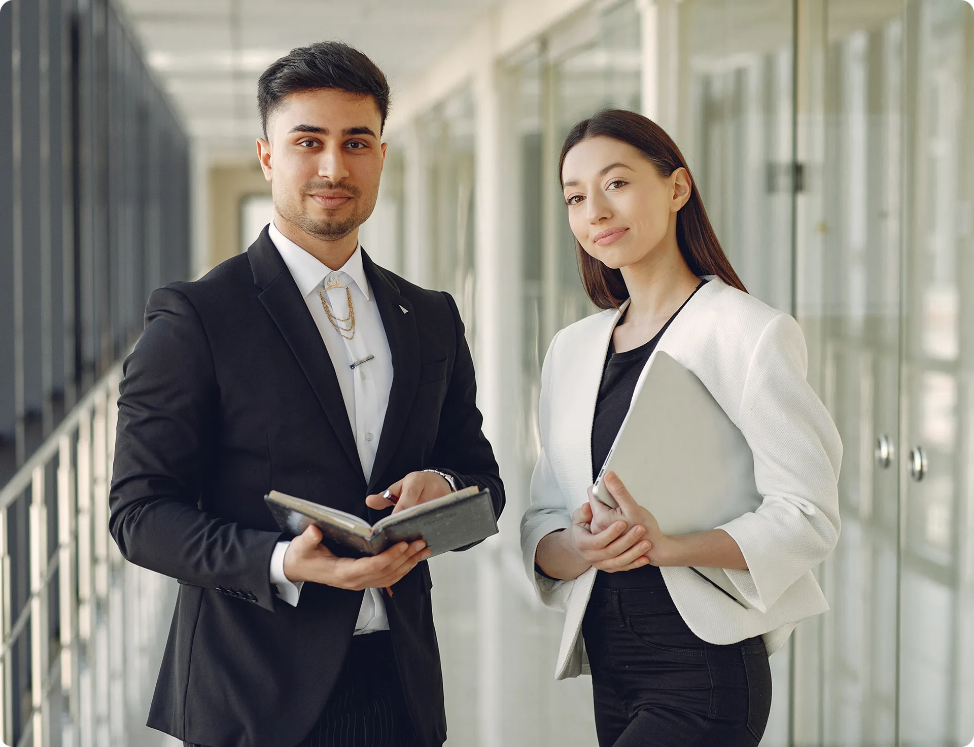 Two colleagues walking together through an office corridor