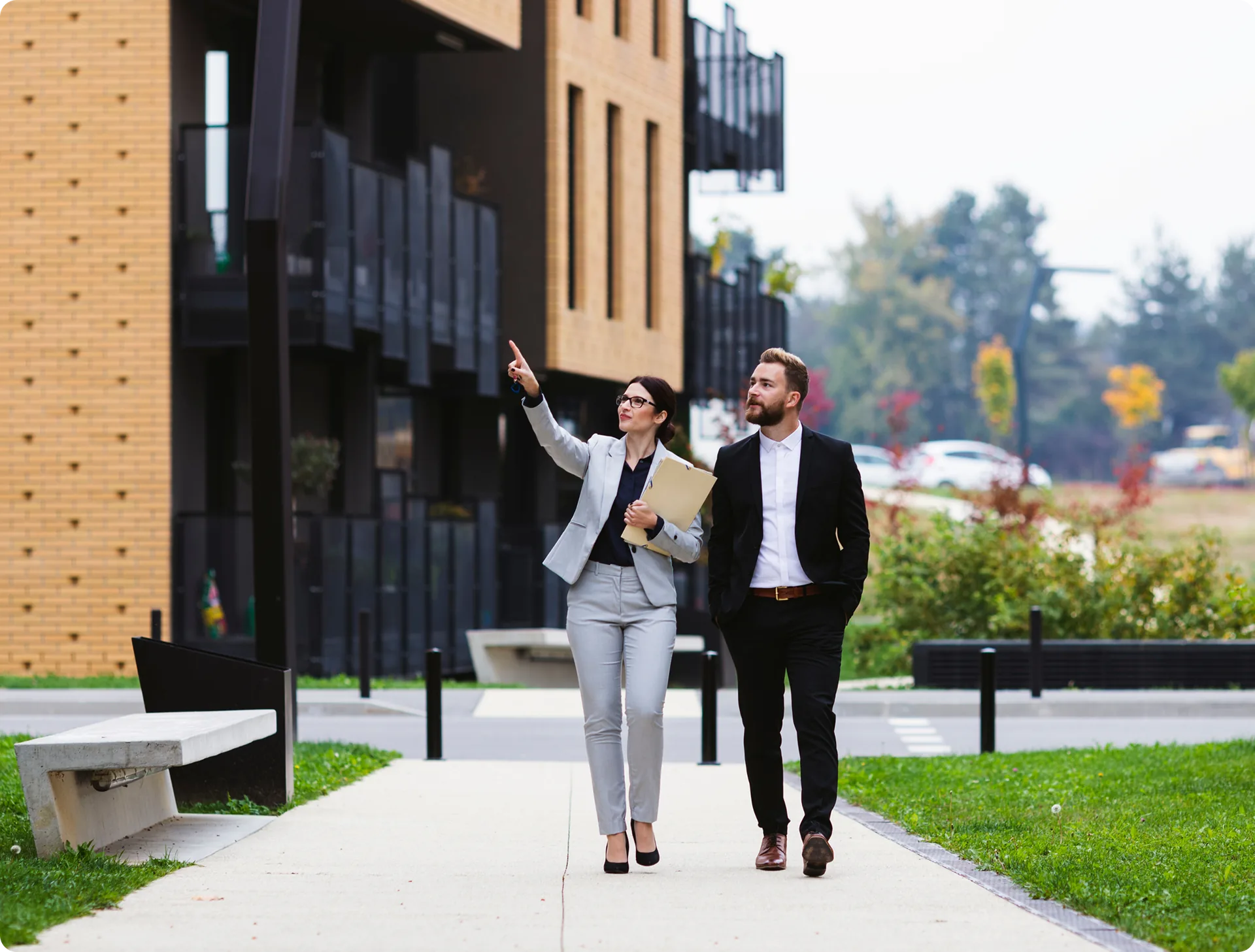 A property manager walking an owner through a residential development