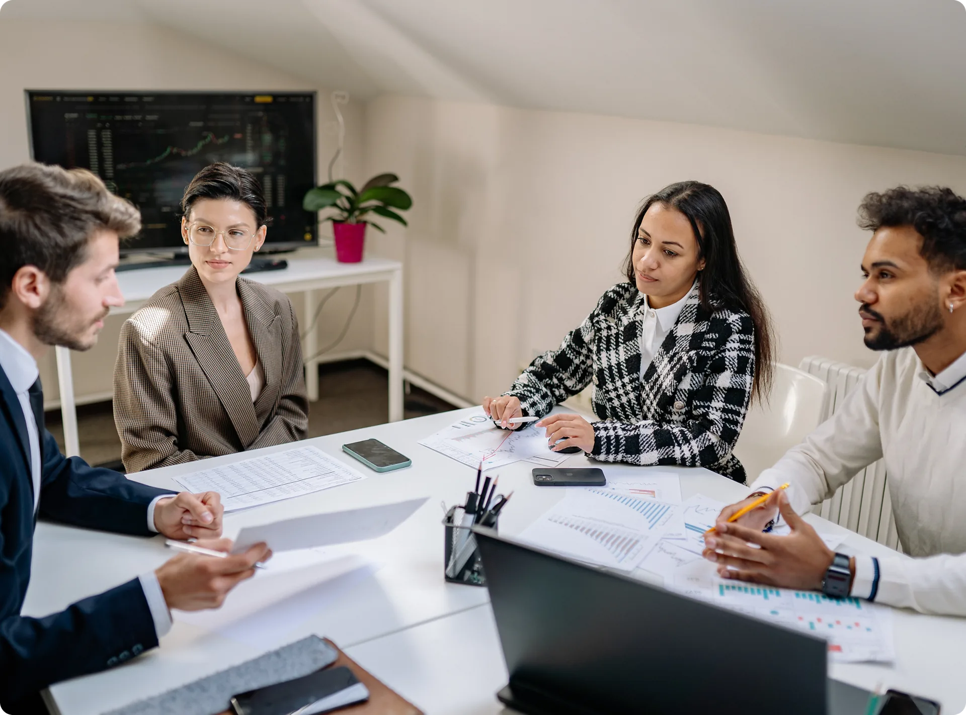 A team reviewing portfolio reports around a boardroom table