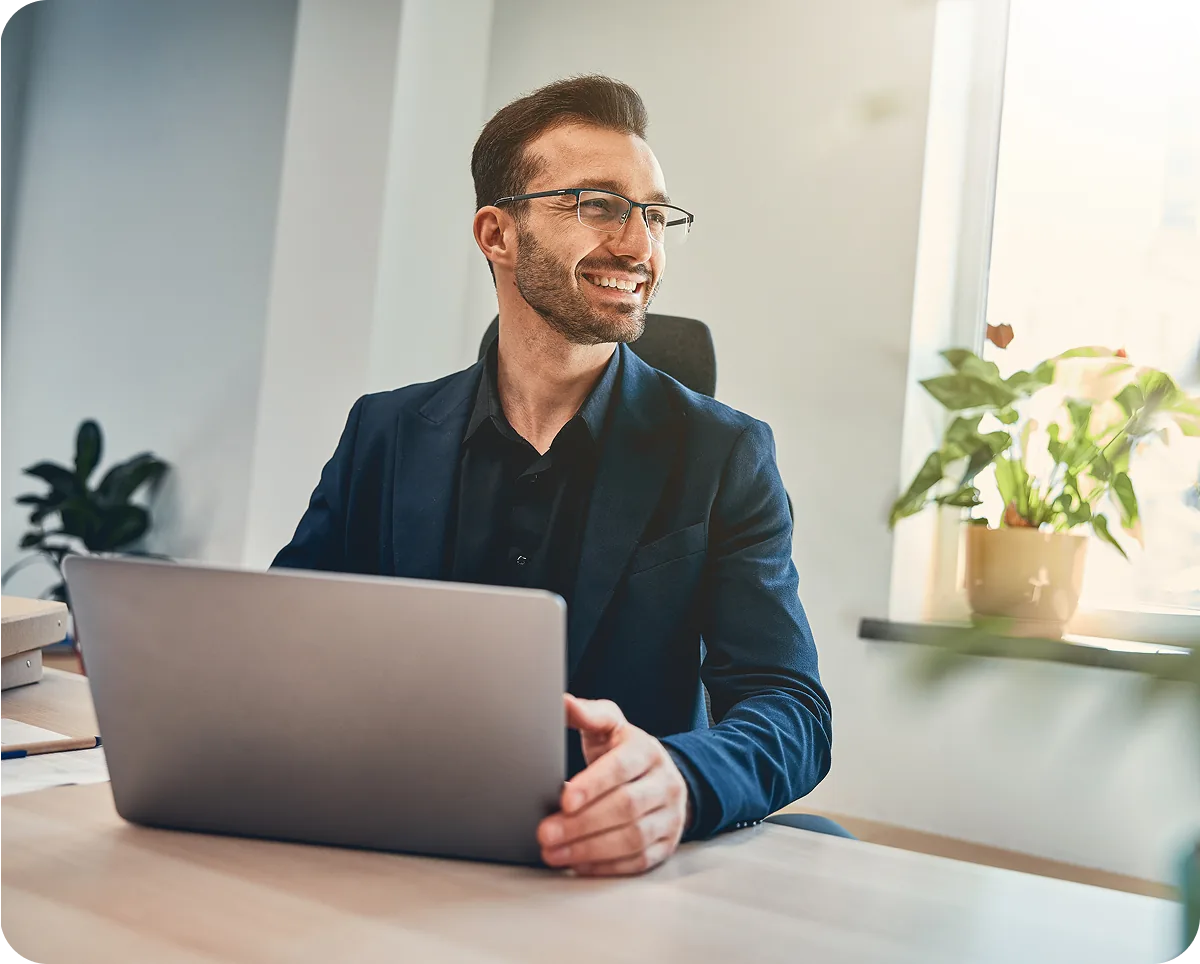 A property manager working at a laptop in a bright office